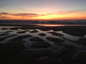 Low tide mirroring the sunset Westerland beach, Sylt, North Sea, Germany